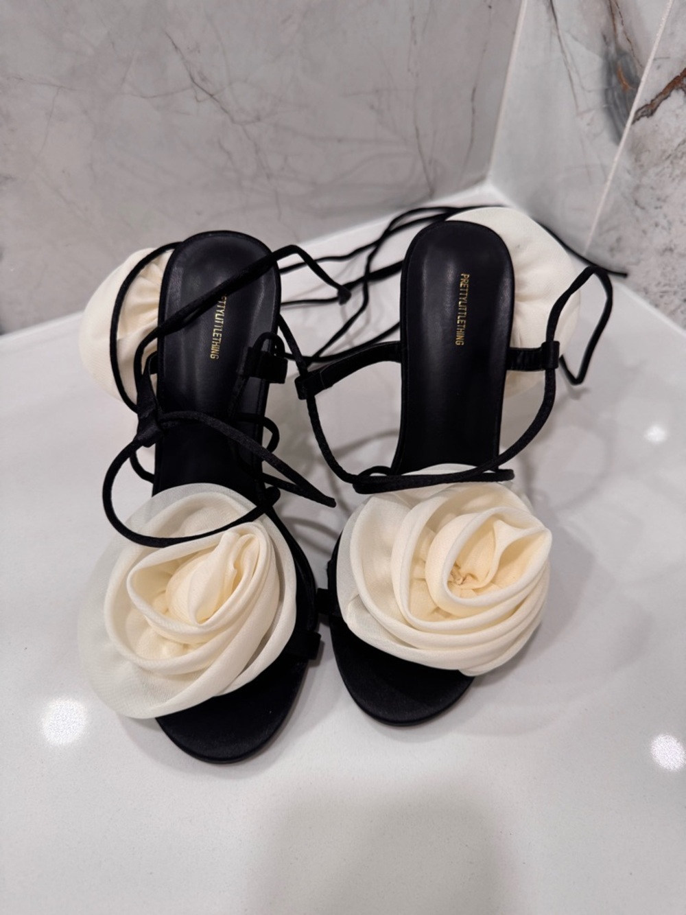 Elegant Black Strappy Sandals with Cream Floral Accent